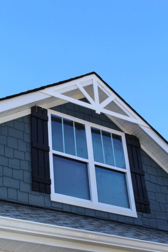 Black shutters installed on a gable window